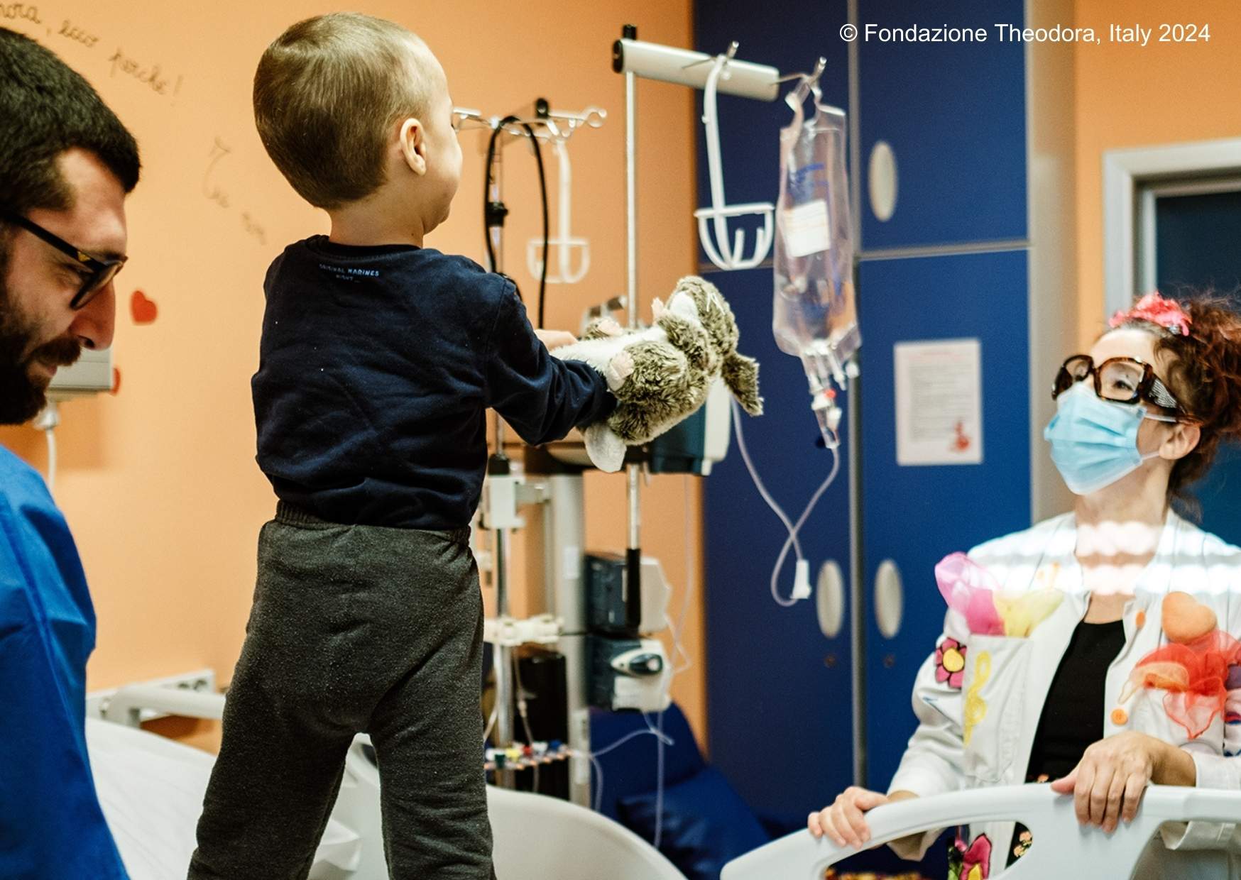 Child in surgery with a medical worker and a medical clown